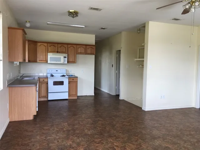 a view of kitchen with cabinets and wooden floor