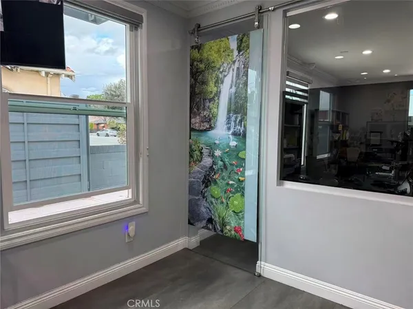 a living room with a large window and flat screen tv