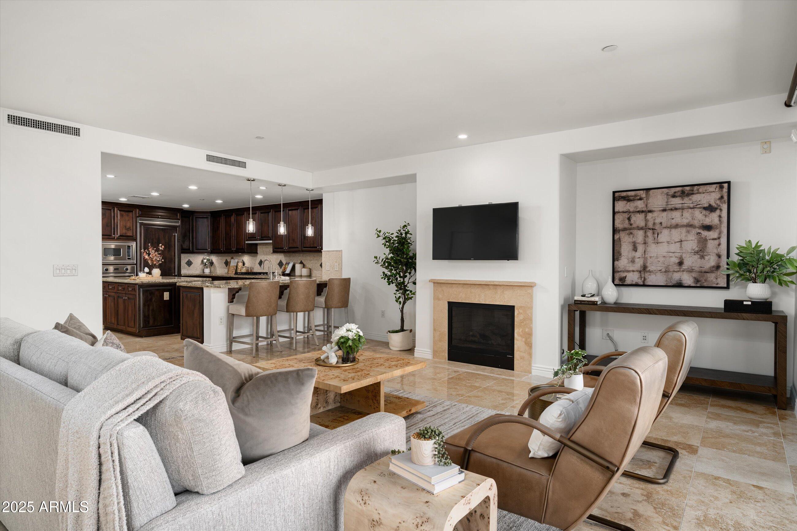 7175 East Camelback Road, Unit 510 Scottsdale, AZ 85251 - Photo 13 of 34 a living room with furniture and a fireplace