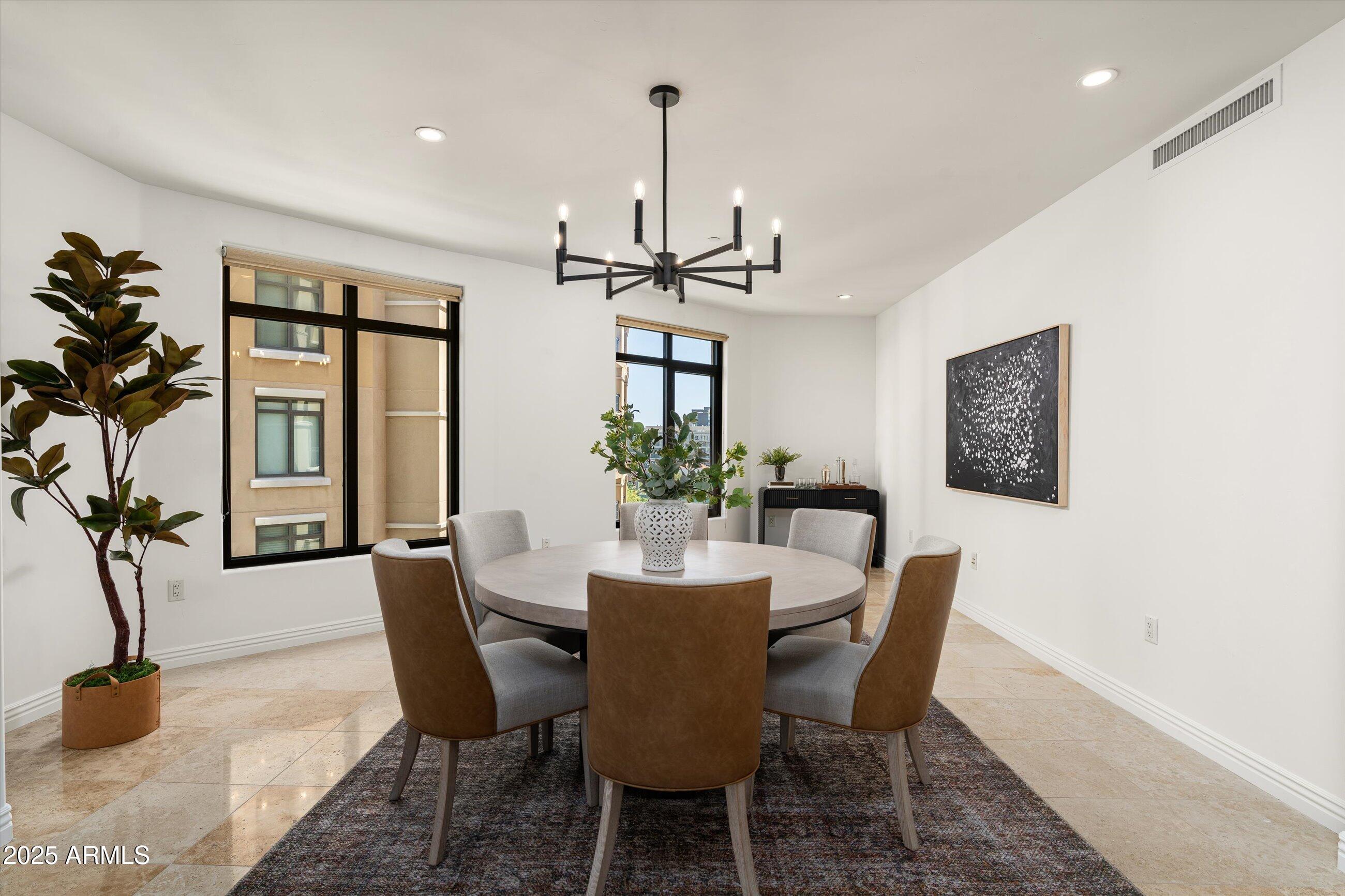 7175 East Camelback Road, Unit 510 Scottsdale, AZ 85251 - Photo 14 of 34 a dining room with furniture potted plants and wooden floor