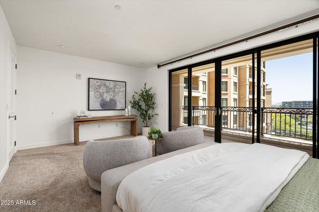 a bedroom with a large bed and a large window