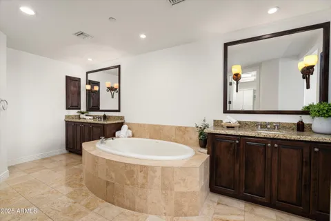 a bathroom with a bathtub sink and mirror