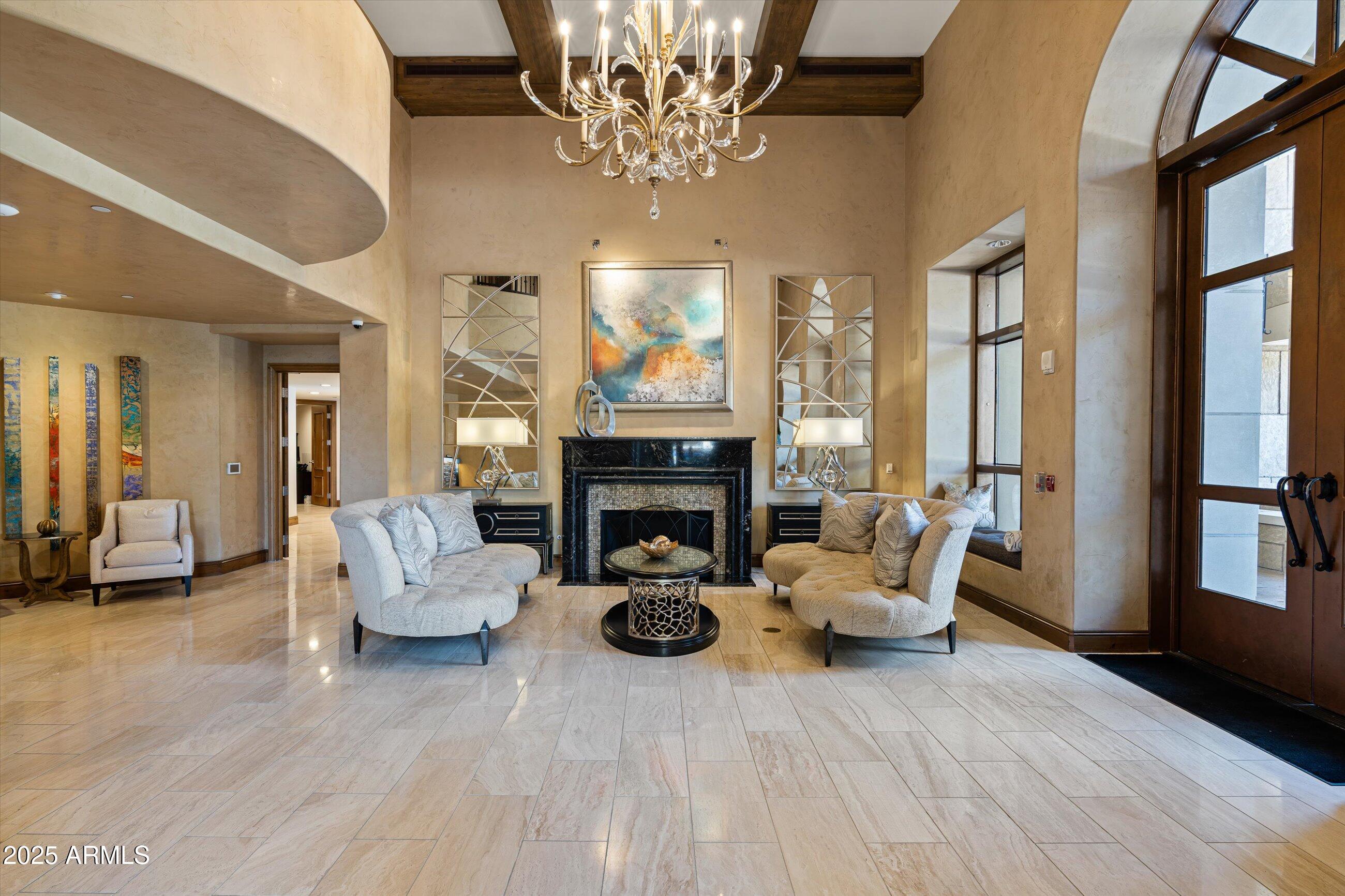 7175 East Camelback Road, Unit 510 Scottsdale, AZ 85251 - Photo 21 of 34 a living room with furniture a chandelier and a fireplace