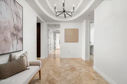 a living room with furniture and a chandelier