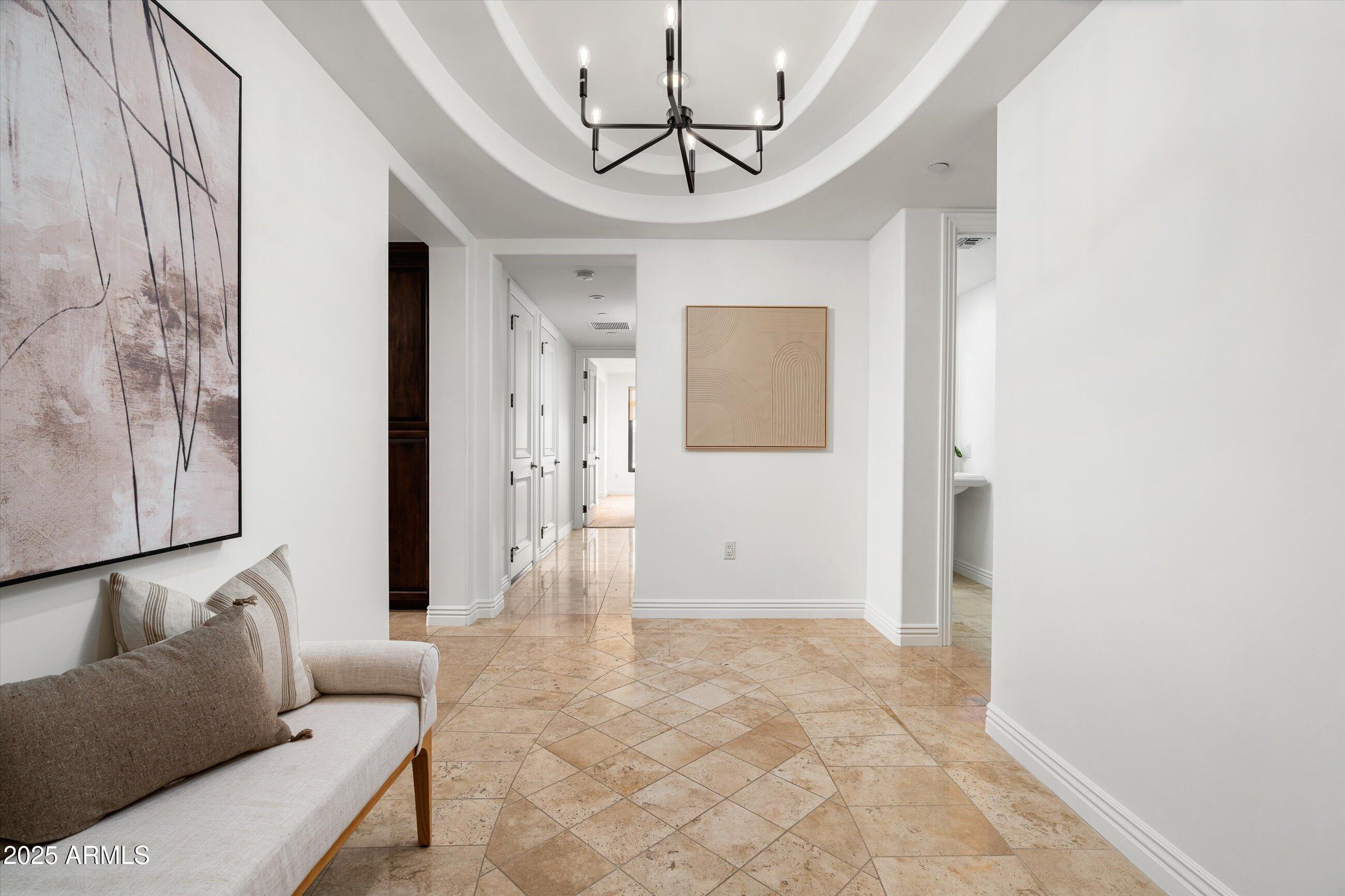 7175 East Camelback Road, Unit 510 Scottsdale, AZ 85251 - Photo 3 of 34 a living room with furniture and a chandelier