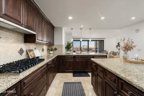 a kitchen with kitchen island granite countertop a sink and stove