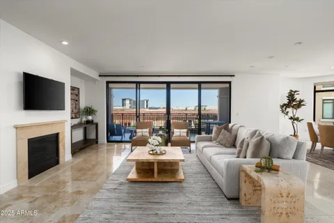 a living room with furniture a flat screen tv and a fireplace