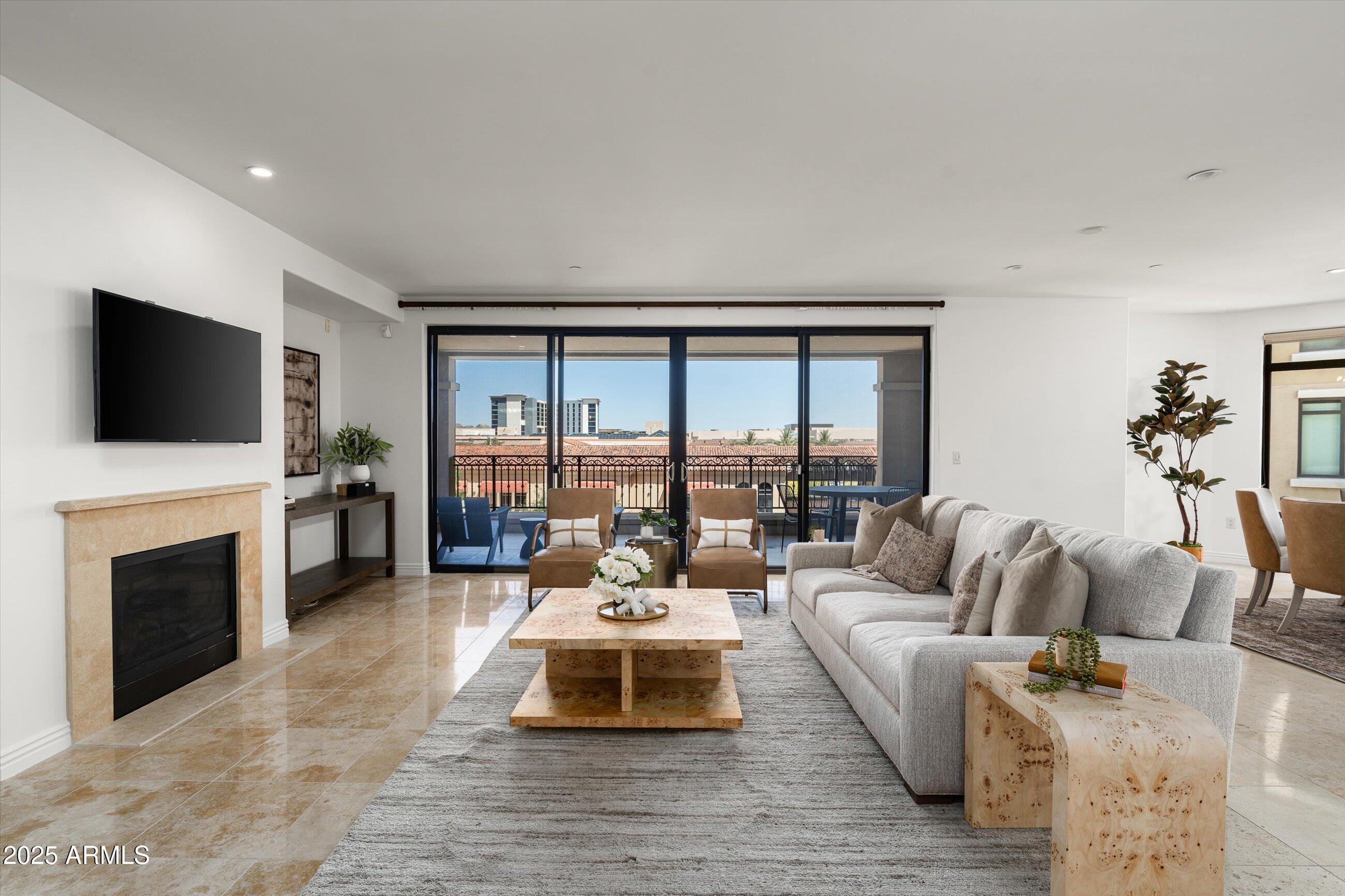 7175 East Camelback Road, Unit 510 Scottsdale, AZ 85251 - Photo 8 of 34 a living room with furniture a flat screen tv and a fireplace