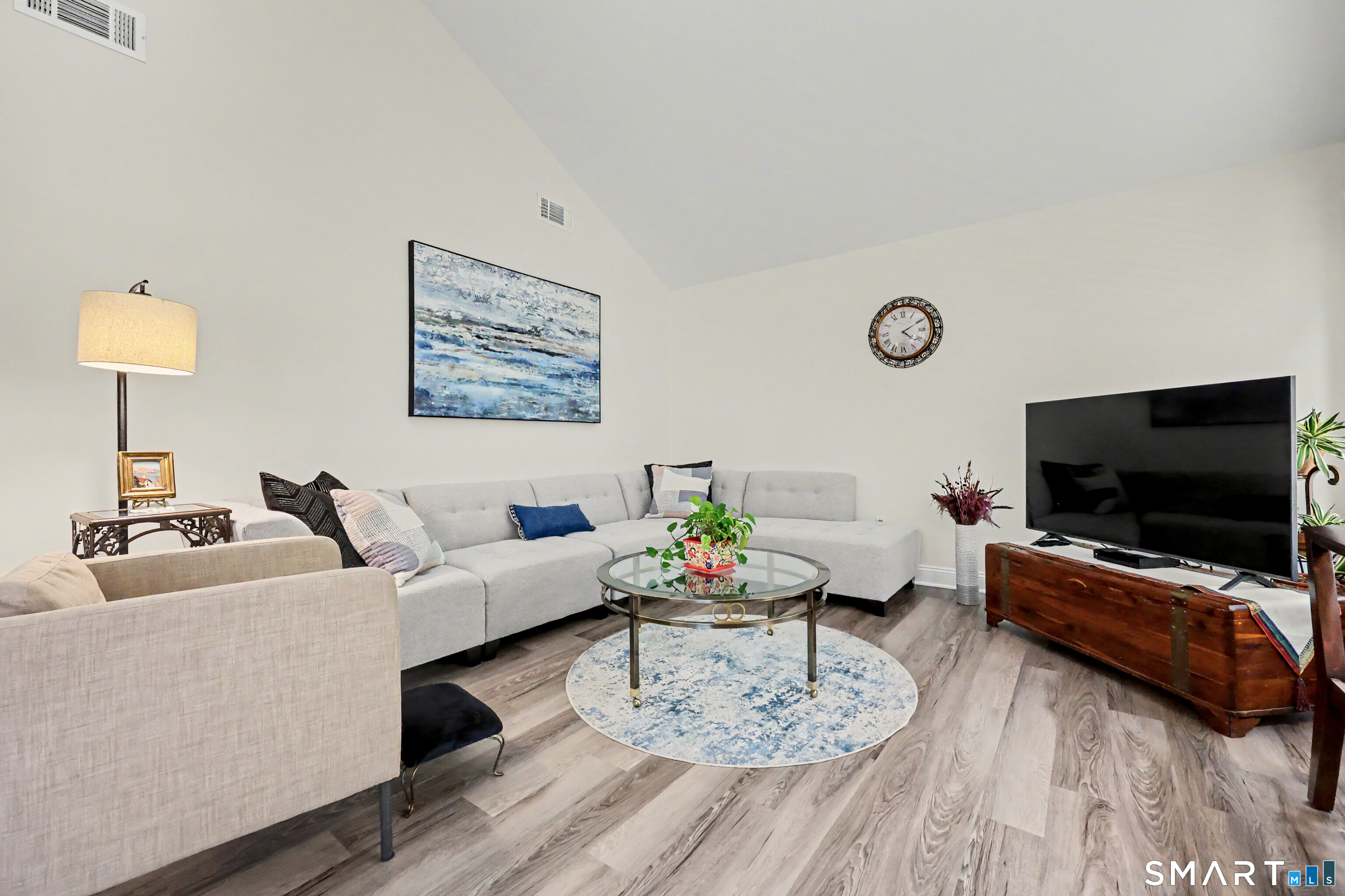 70 Fawn Ridge Lane, Unit 70 Norwalk, CT 06851 - Photo 3 of 36 a living room with furniture and a flat screen tv