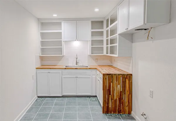 a view of a sink and cabinets