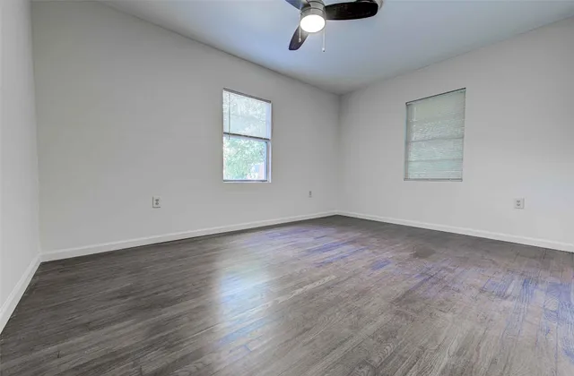 a view of an empty room and wooden floor