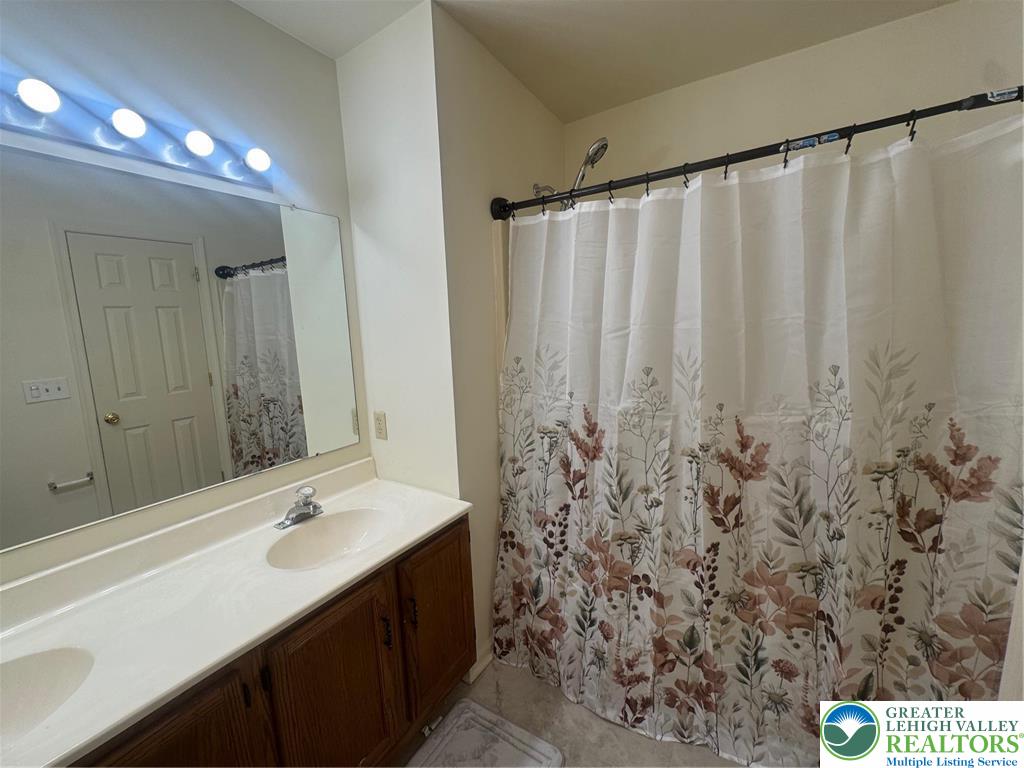 318 Mickley Road Whitehall, PA 18052 - Photo 12 of 25 a bathroom with a sink and a mirror