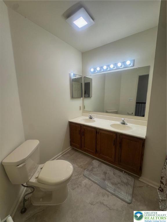 318 Mickley Road Whitehall, PA 18052 - Photo 13 of 25 a bathroom with a toilet sink double vanity and mirror