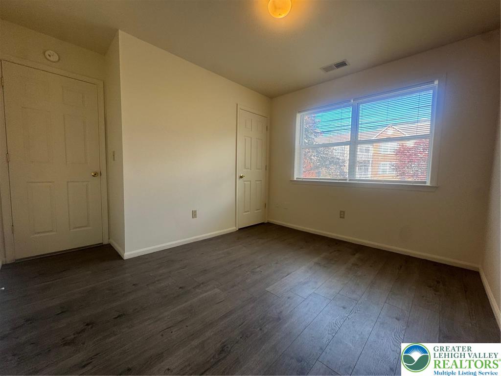 318 Mickley Road Whitehall, PA 18052 - Photo 14 of 25 an empty room with wooden floor and windows