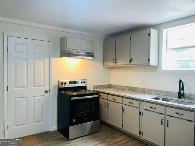a kitchen with appliances cabinets and a window