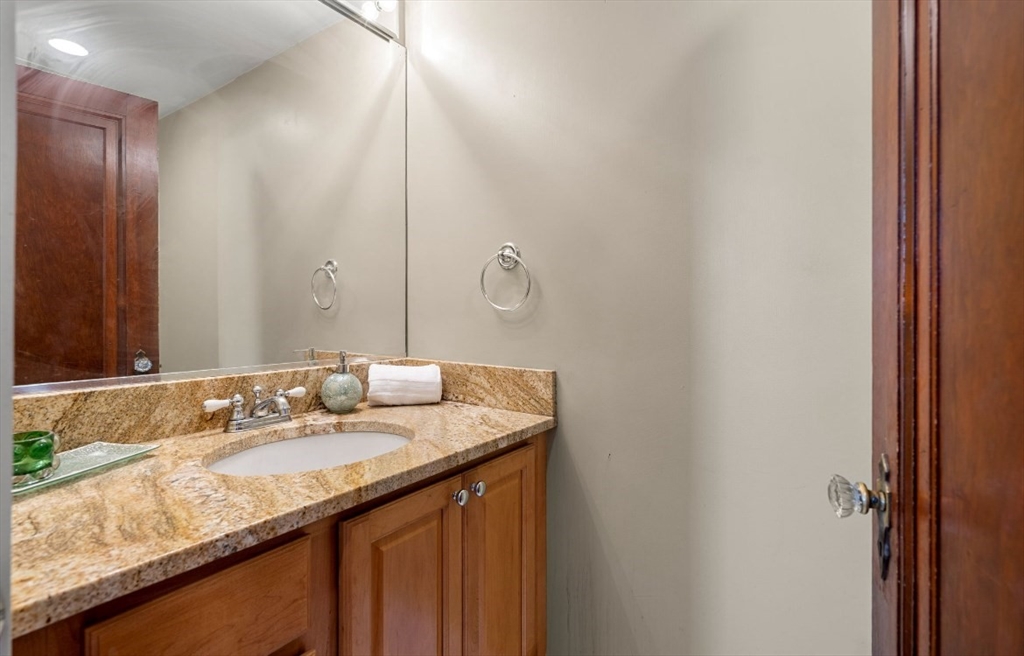 15 Lexington Terrace, Unit 1 Waltham, MA 02452 - Photo 11 of 13 a bathroom with a granite countertop sink and a mirror