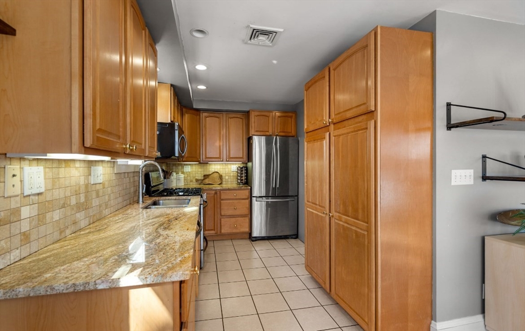 15 Lexington Terrace, Unit 1 Waltham, MA 02452 - Photo 7 of 13 a kitchen with stainless steel appliances granite countertop a refrigerator and a sink