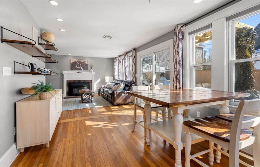 15 Lexington Terrace, Unit 1 Waltham, MA 02452 - Photo 9 of 13 a living room with furniture a fireplace and a table