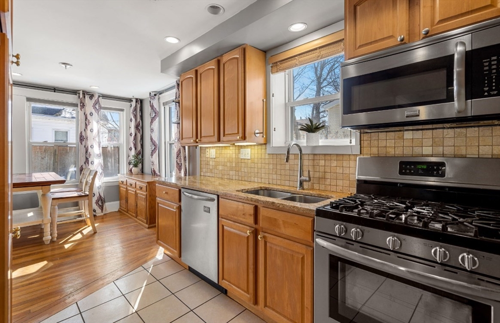 15 Lexington Terrace, Unit 1 Waltham, MA 02452 - Photo 10 of 13 a kitchen with a stove a sink and a microwave