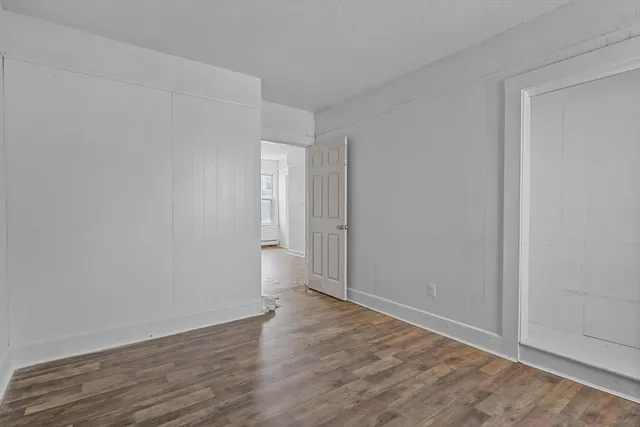 a view of an empty room and wooden floor