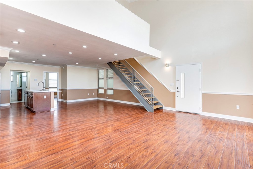 596 South Brea Boulevard Brea, CA 92821 - Photo 6 of 33 a view of an empty room with wooden floor and stairs