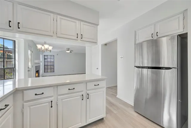 a kitchen with stainless steel appliances granite countertop a refrigerator and a sink