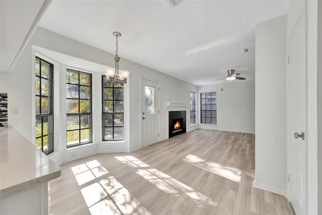 a view of an empty room with window and fireplace