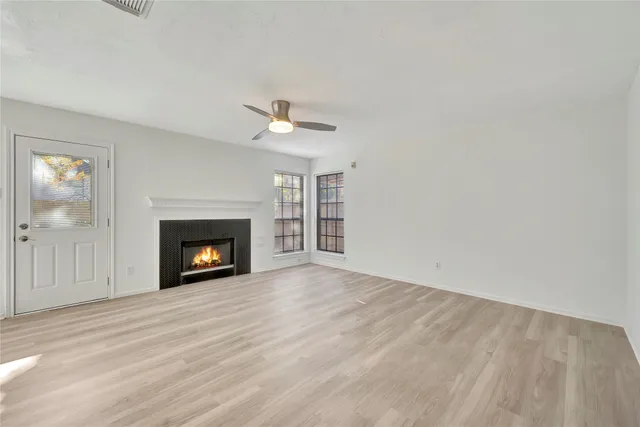 a view of an empty room with a fireplace