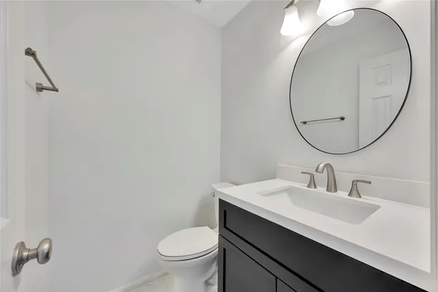 a bathroom with a sink a toilet and a mirror