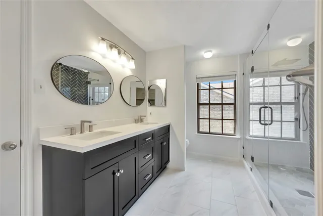 a bathroom with a double vanity sink and a mirror