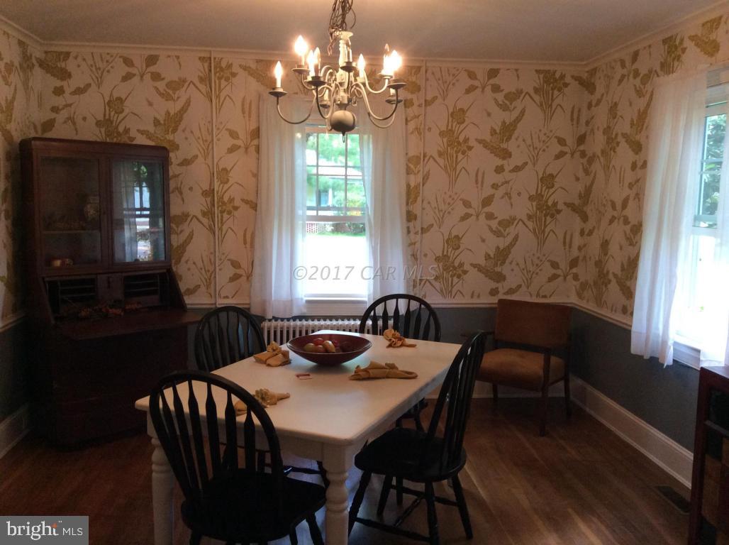 20502 Nanticoke Road Nanticoke, MD 21840 - Photo 13 of 27 a dining room with furniture a chandelier and window