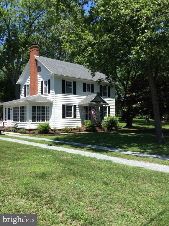 20502 Nanticoke Road Nanticoke, MD 21840 - Photo 15 of 27 a front view of a house with a yard porch and trees