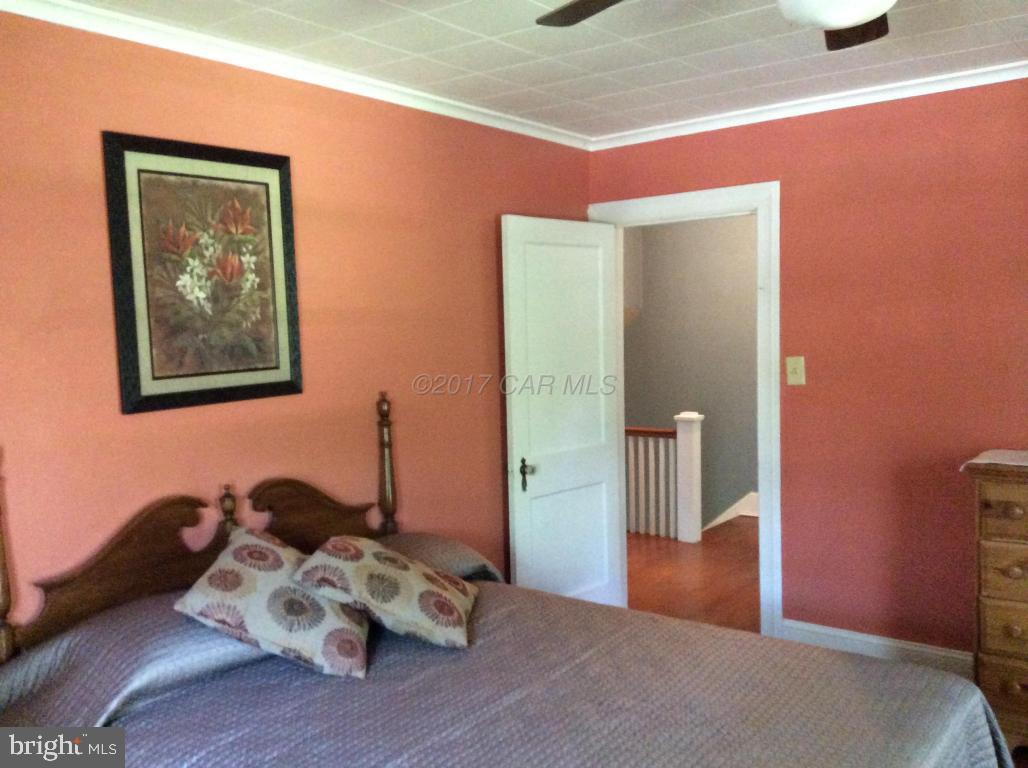 20502 Nanticoke Road Nanticoke, MD 21840 - Photo 19 of 27 a bedroom with bed and wooden floor