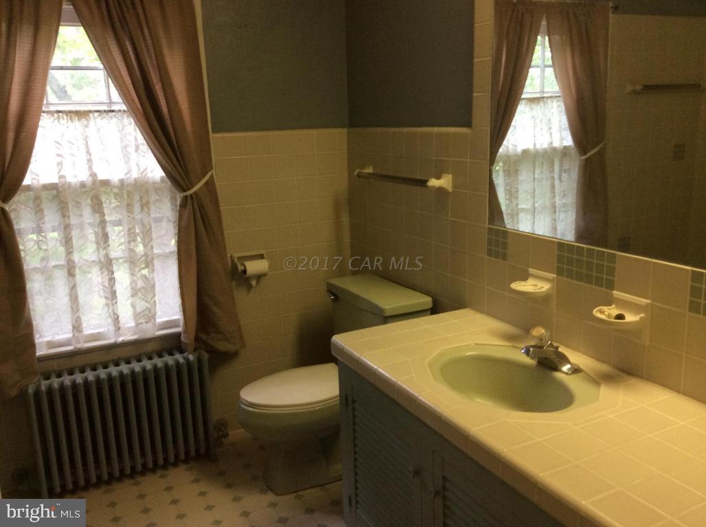 20502 Nanticoke Road Nanticoke, MD 21840 - Photo 26 of 27 a bathroom with a sink toilet and window