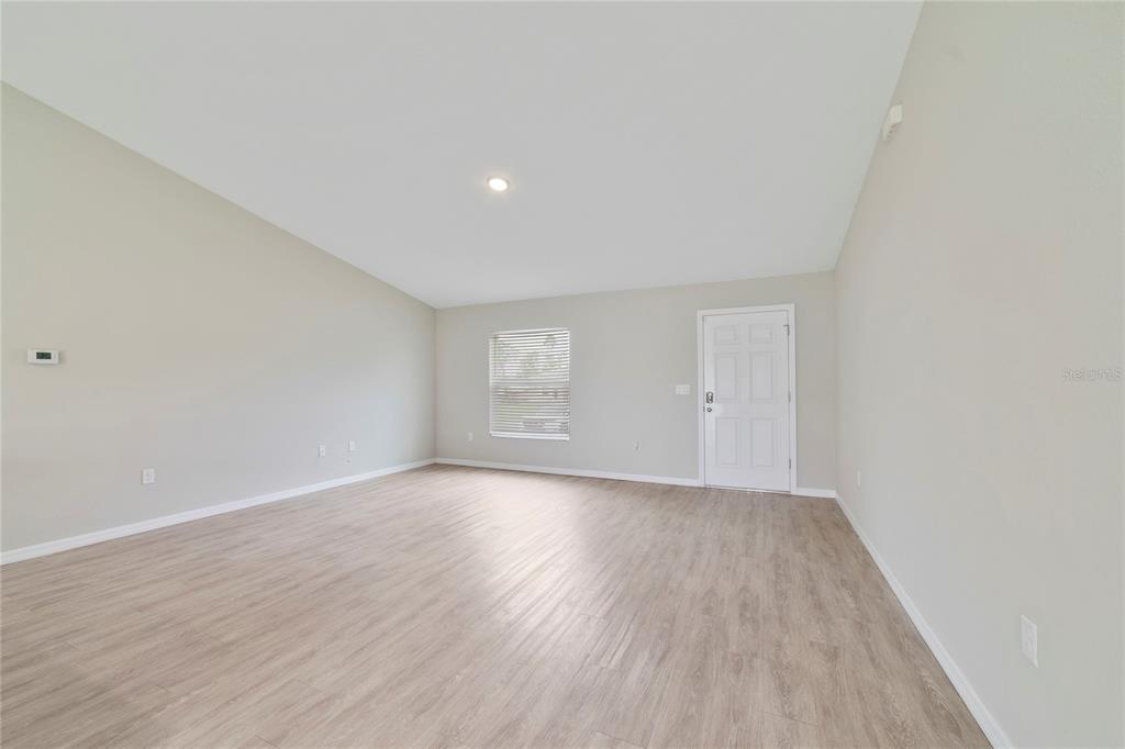 16271 Southwest 27th Terrace Road Ocala, FL 34473 - Photo 14 of 21 a view of an empty room with wooden floor and a window