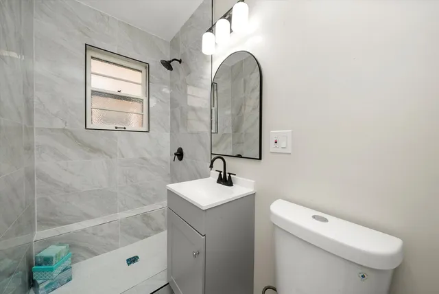 a bathroom with a sink toilet and shower