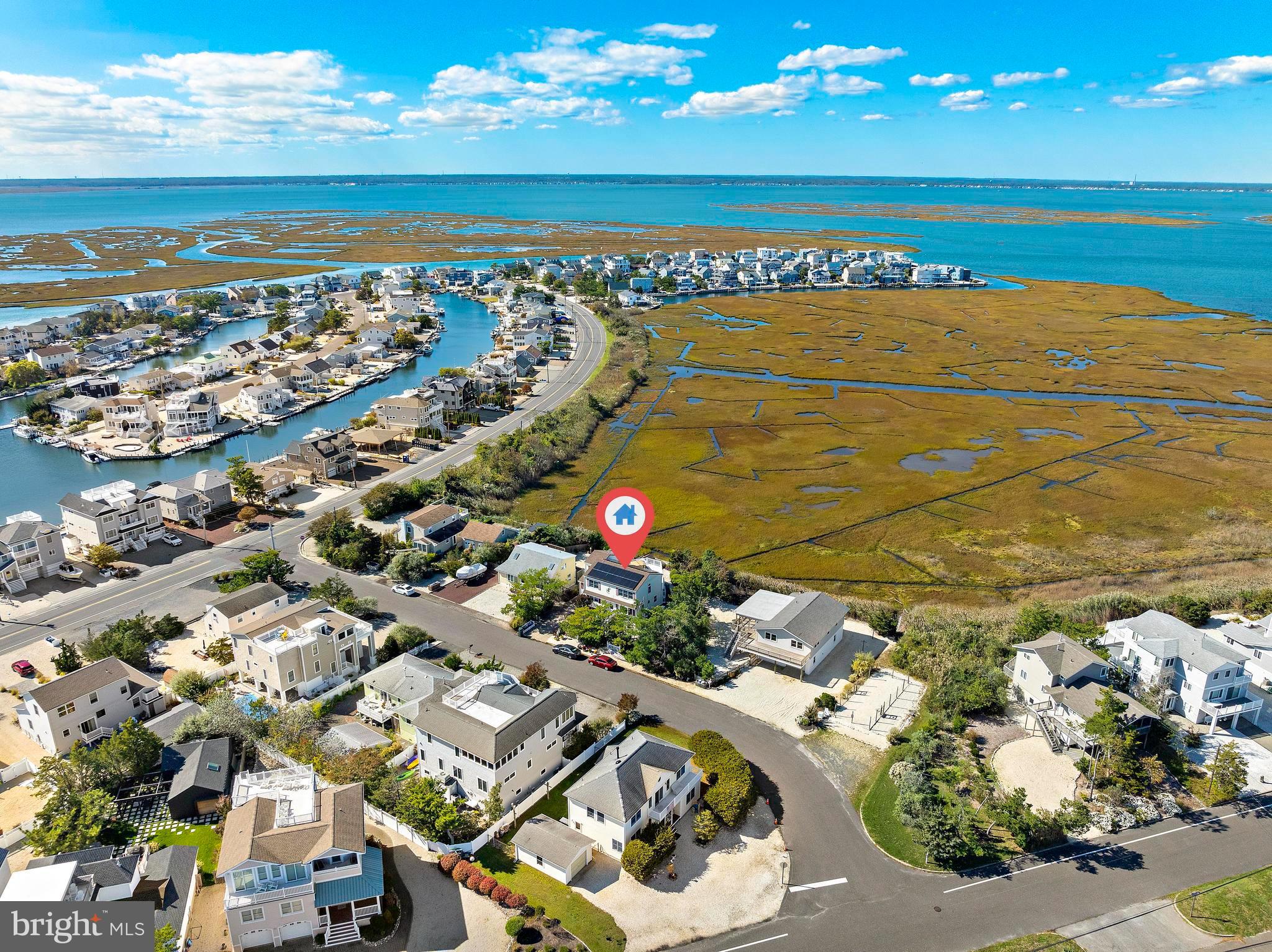 6 Collier Road Long Beach Township, NJ 08006 - Photo 20 of 24 a view of an ocean and a houses
