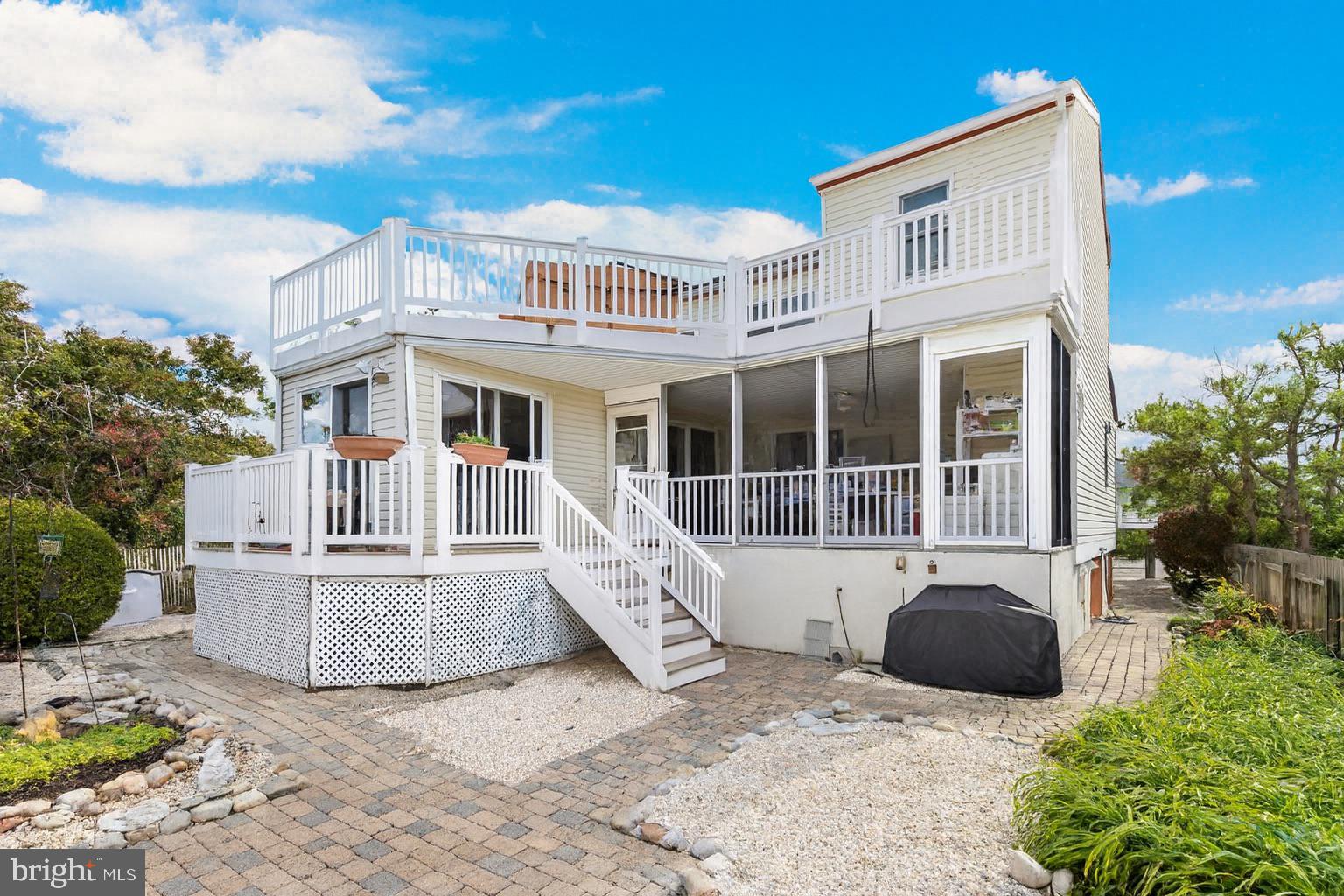 6 Collier Road Long Beach Township, NJ 08006 - Photo 8 of 24 a view of white house with a yard and seating space