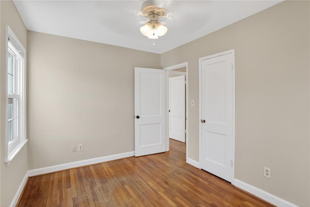 578 Goldsboro Road Northeast, Unit D Atlanta, GA 30307 - Photo 11 of 20 a view of an empty room with wooden floor and a window