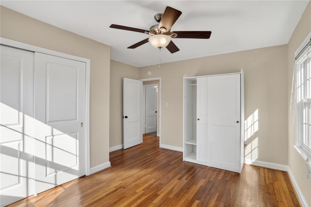 578 Goldsboro Road Northeast, Unit D Atlanta, GA 30307 - Photo 13 of 20 a view of an empty room with wooden floor and a window