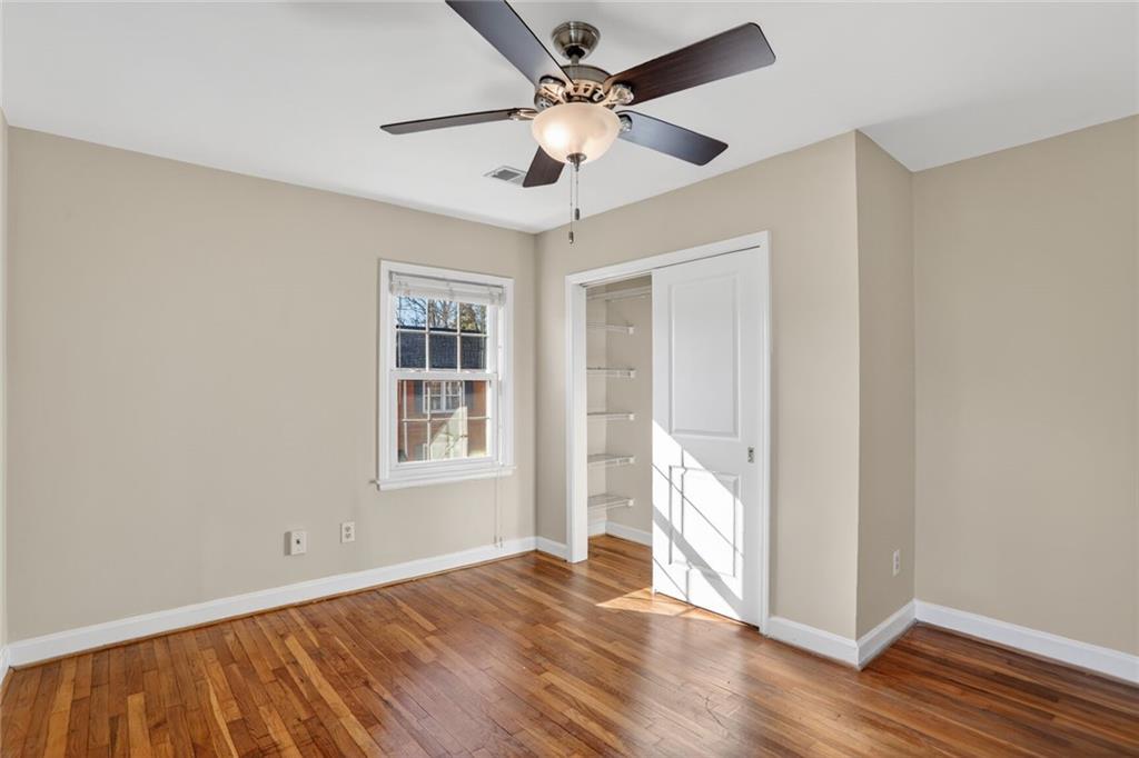 578 Goldsboro Road Northeast, Unit D Atlanta, GA 30307 - Photo 15 of 20 a view of an empty room with wooden floor and a window