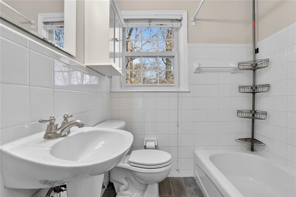 578 Goldsboro Road Northeast, Unit D Atlanta, GA 30307 - Photo 16 of 20 a bathroom with a sink and mirror with toilet