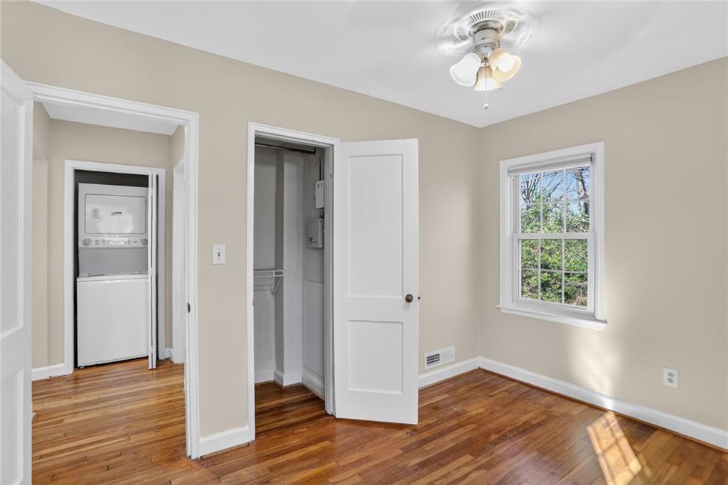 578 Goldsboro Road Northeast, Unit D Atlanta, GA 30307 - Photo 18 of 20 a view of an empty room with wooden floor and a window