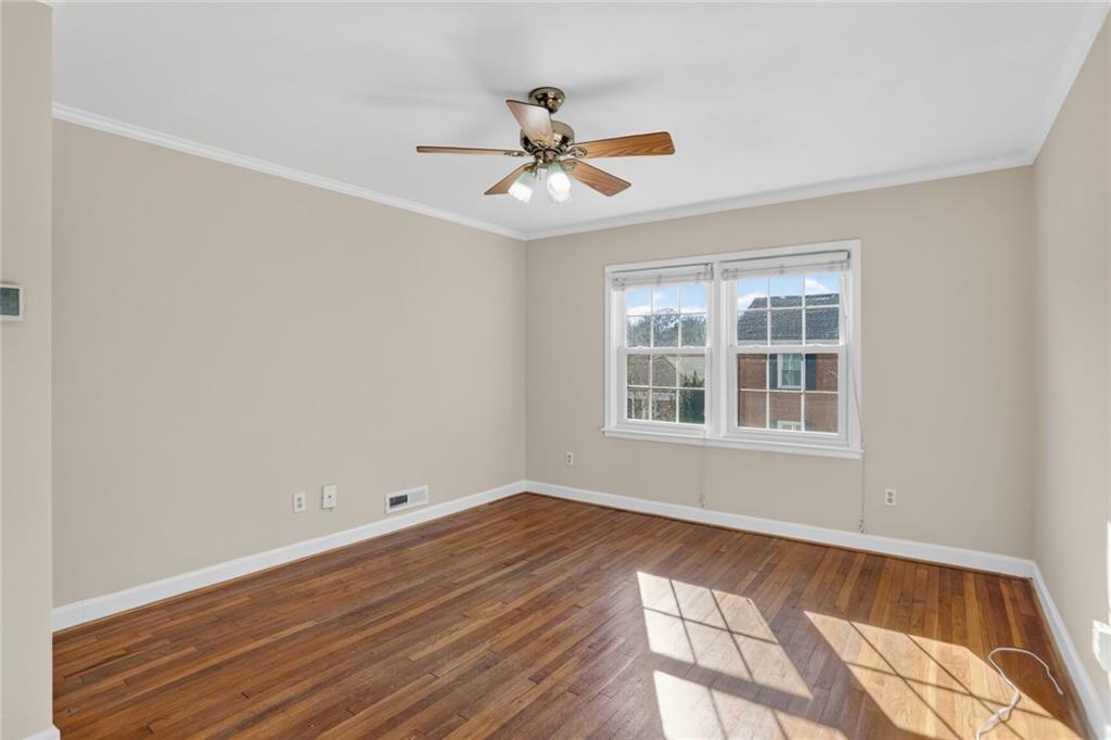578 Goldsboro Road Northeast, Unit D Atlanta, GA 30307 - Photo 2 of 20 a view of an empty room with wooden floor and a window