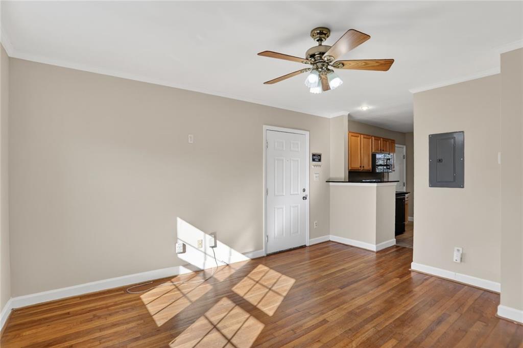 578 Goldsboro Road Northeast, Unit D Atlanta, GA 30307 - Photo 4 of 20 a view of a kitchen with wooden floor and a ceiling fan