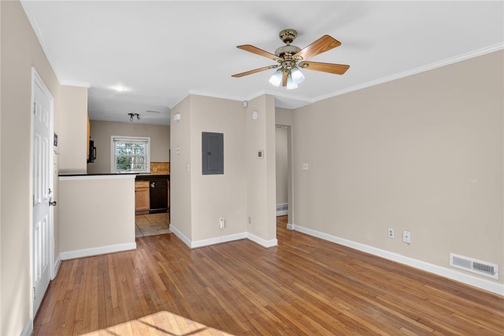 578 Goldsboro Road Northeast, Unit D Atlanta, GA 30307 - Photo 5 of 20 a view of a kitchen with wooden floor and a ceiling fan
