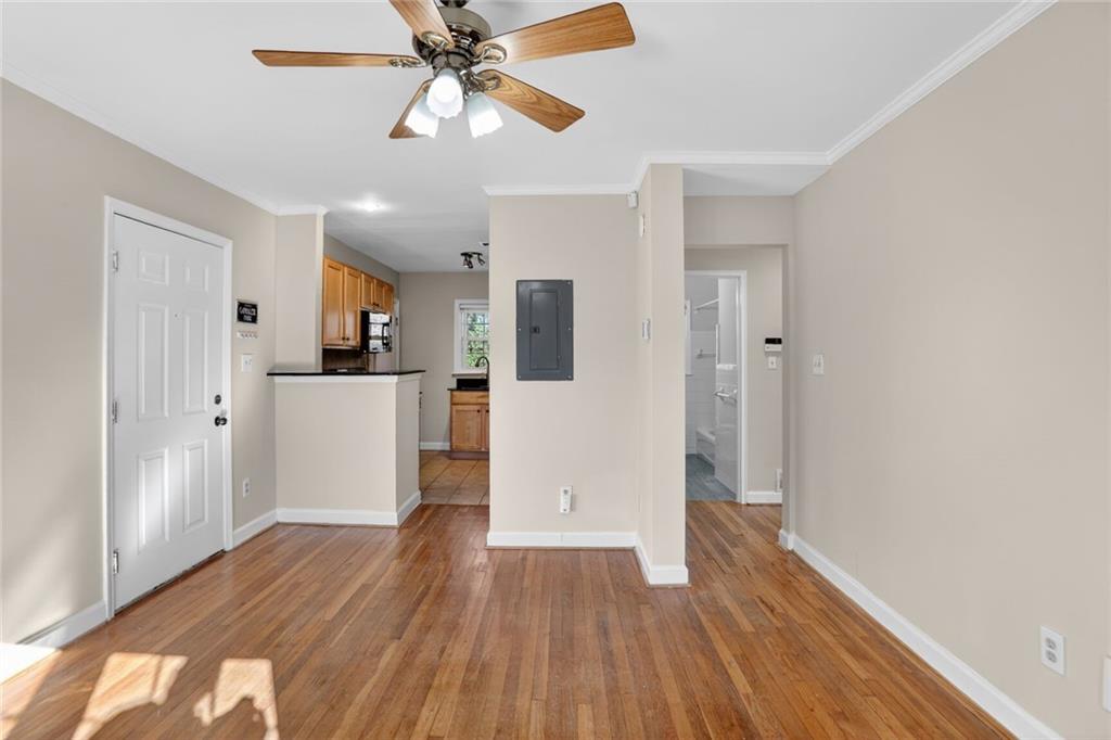 578 Goldsboro Road Northeast, Unit D Atlanta, GA 30307 - Photo 6 of 20 a view of a kitchen with wooden floor and a ceiling fan