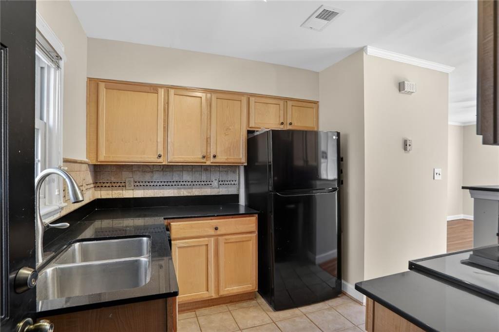578 Goldsboro Road Northeast, Unit D Atlanta, GA 30307 - Photo 8 of 20 a kitchen with a refrigerator and a sink