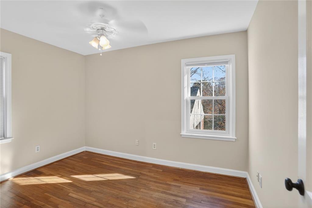 578 Goldsboro Road Northeast, Unit D Atlanta, GA 30307 - Photo 9 of 20 an empty room with wooden floor and windows