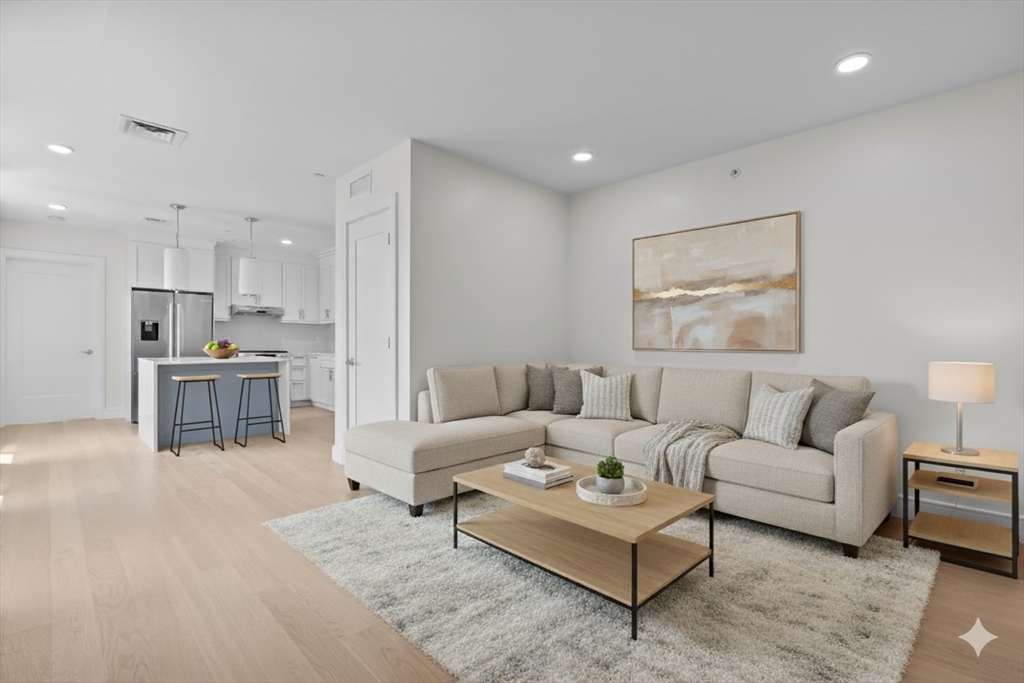 a living room with furniture and kitchen view